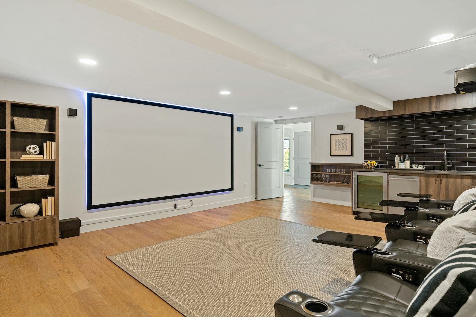 Media room with a large projection screen and theater seating