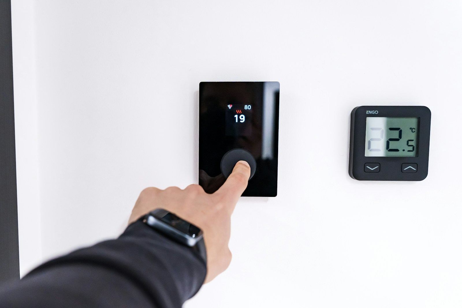 Hand pressing an in-wall control keypad